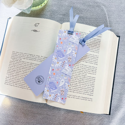 Blue bookmark with a ghost design on top of a book