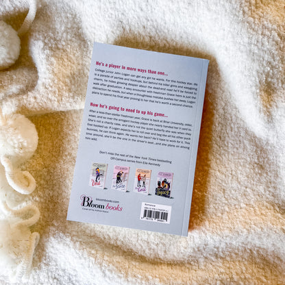 Back cover of a book on a textured surface with 'Bloom Books' branding.