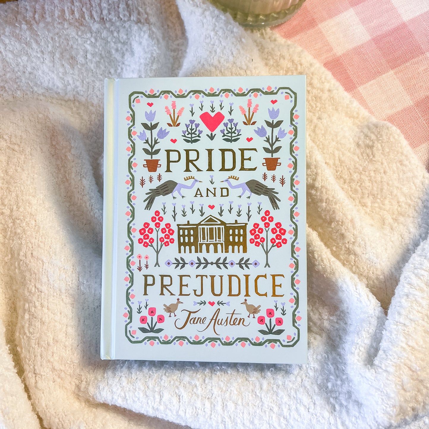 Book titled 'Pride and Prejudice' by Jane Austen on a soft fabric background