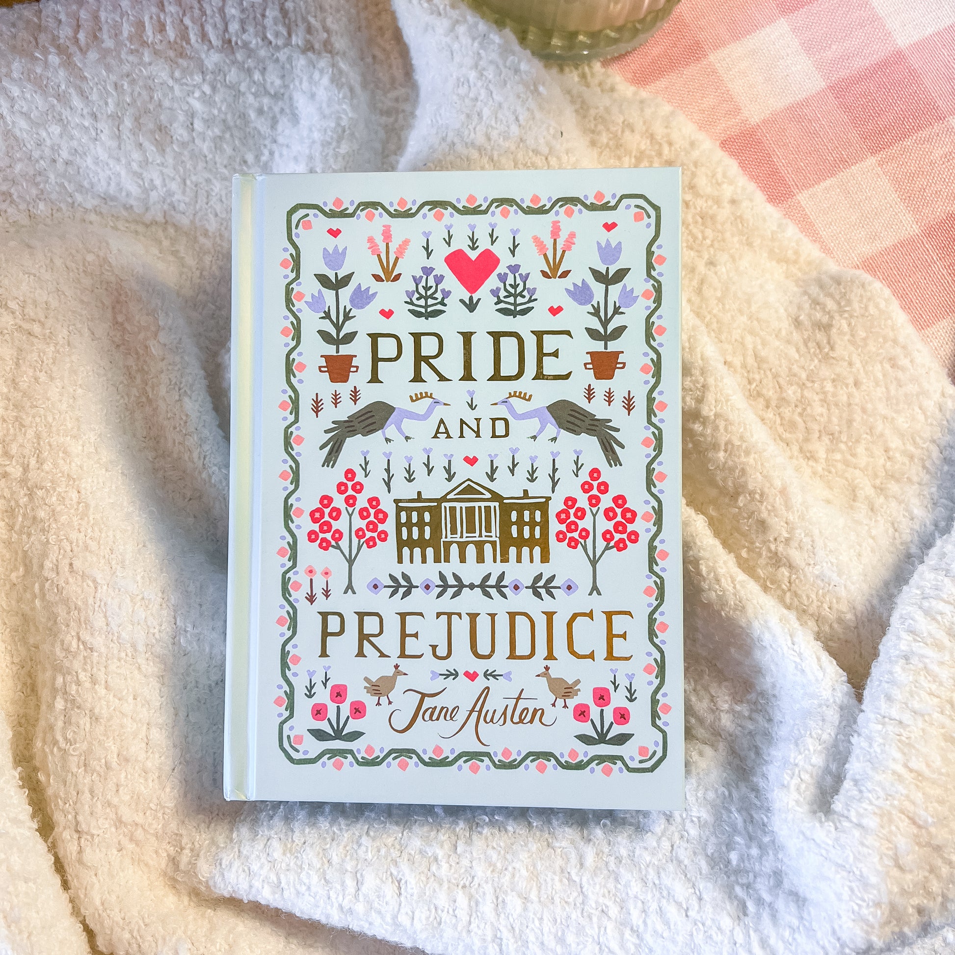Book titled 'Pride and Prejudice' by Jane Austen on a soft fabric background