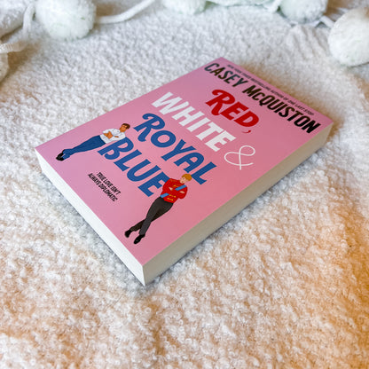 Book titled 'Red, White & Royal Blue' by Casey McQuiston on a white background