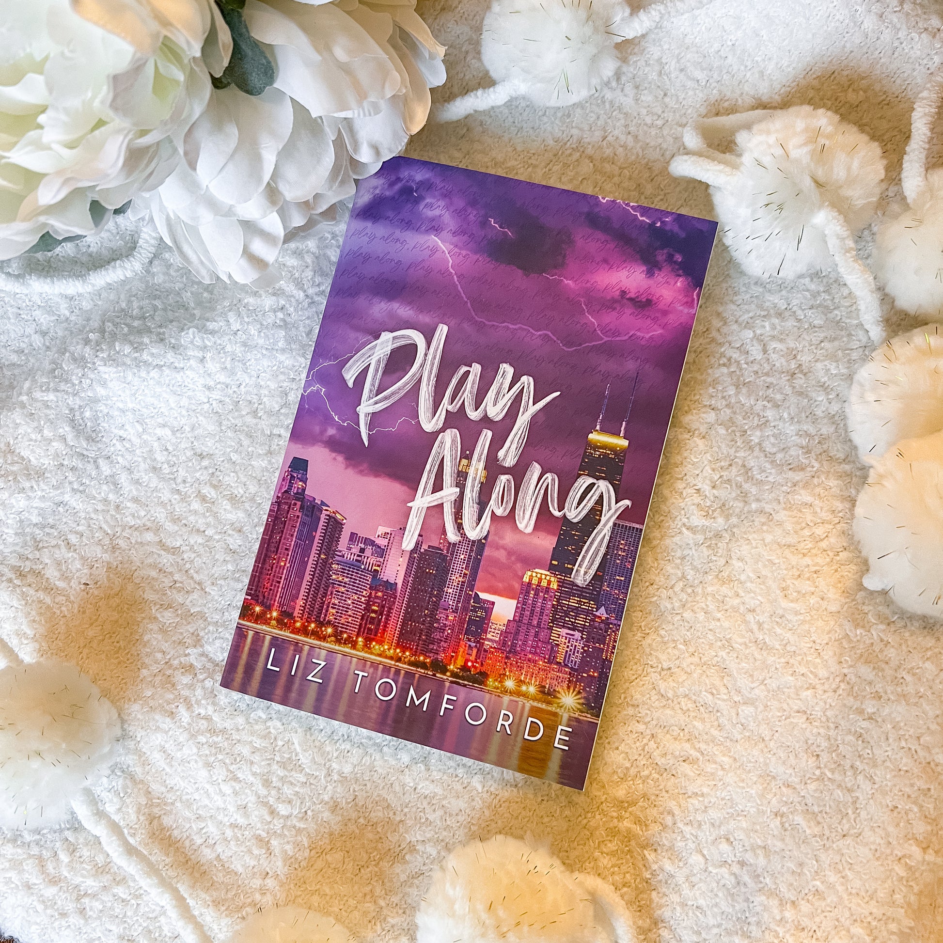 Cover of "play along" by Liz Tomforde on a soft white background.