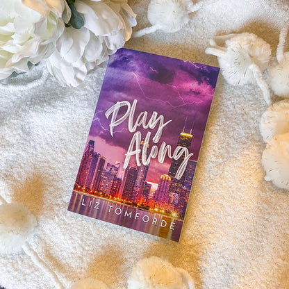 Cover of "play along" by Liz Tomforde on a soft white background.