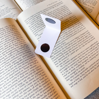 magnetic bookmark open on a book page