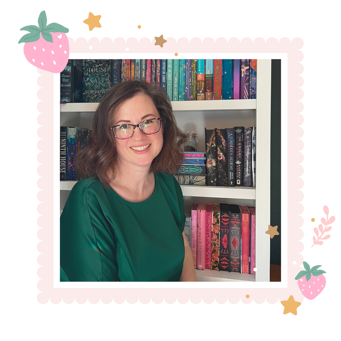 Woman in a green shirt sitting in front of a bookshelf filled with books.