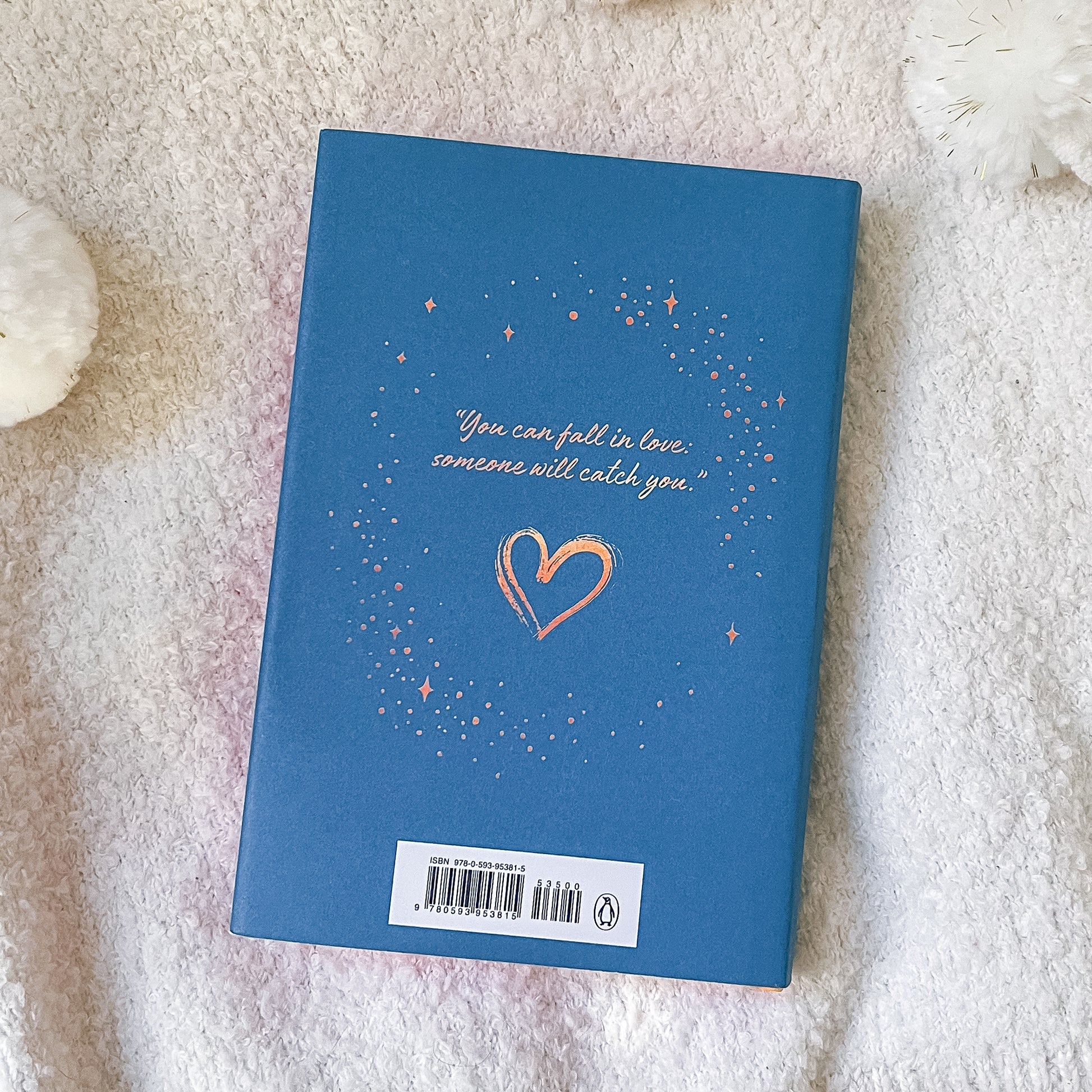 Blue book with a heart and text on a textured surface