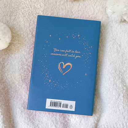 Blue book with a heart and text on a textured surface