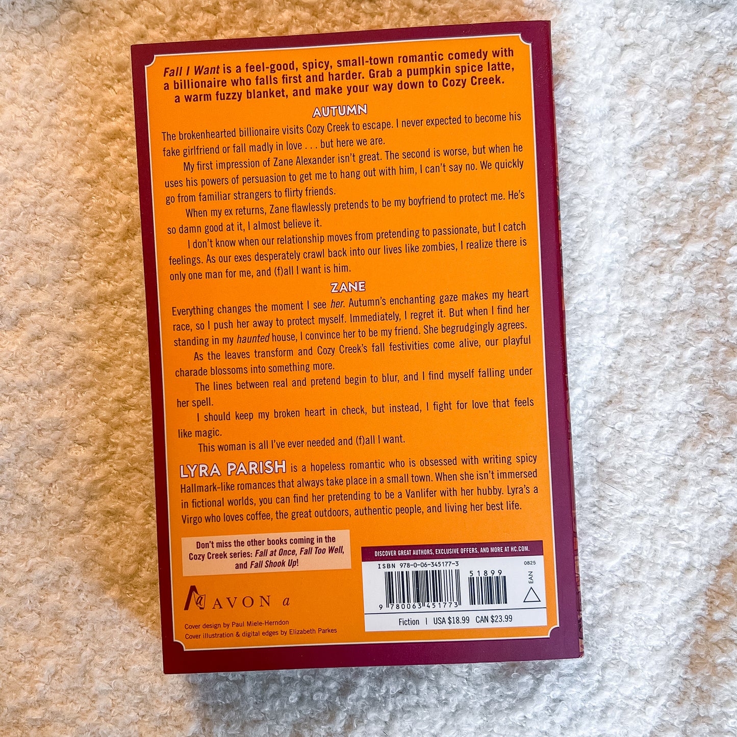 A printed book or booklet cover photographed from above on a white background. The front features a large tan rectangular panel with black text, a small illustrated figure, and a red title at the top.