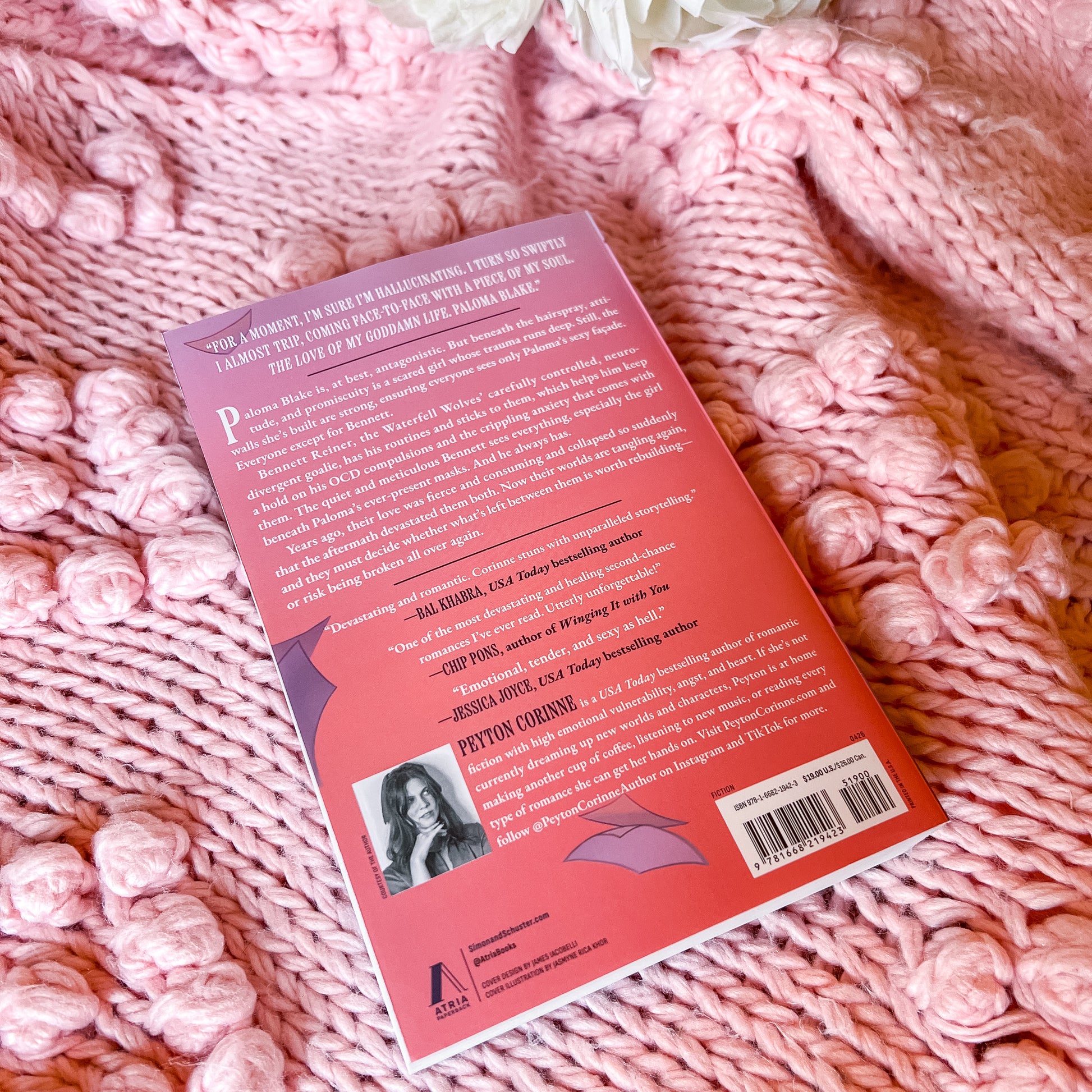 Book back cover on a pink textured fabric background