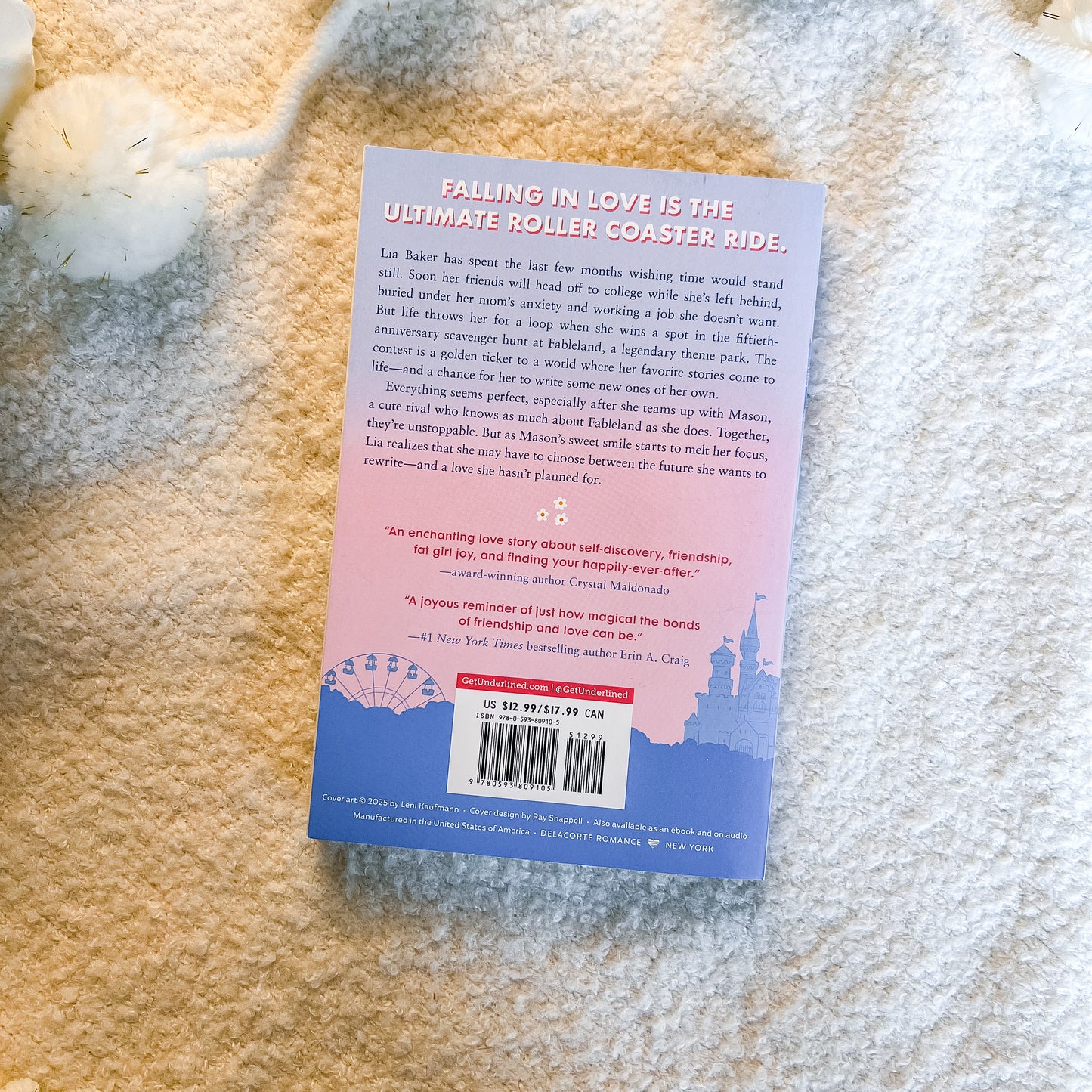 The back cover of the book 'Falling in Love is the Ultimate Roller Coaster Ride' by A. Crag, placed on a textured cream-colored fabric background.