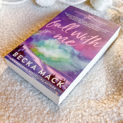 Book titled 'Fall with Me' by Becka Mack on a textured surface