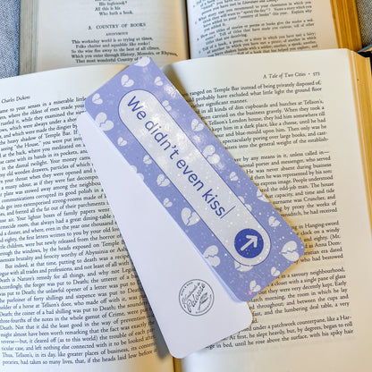 Bookmark with 'We didn't even kiss' text on a book