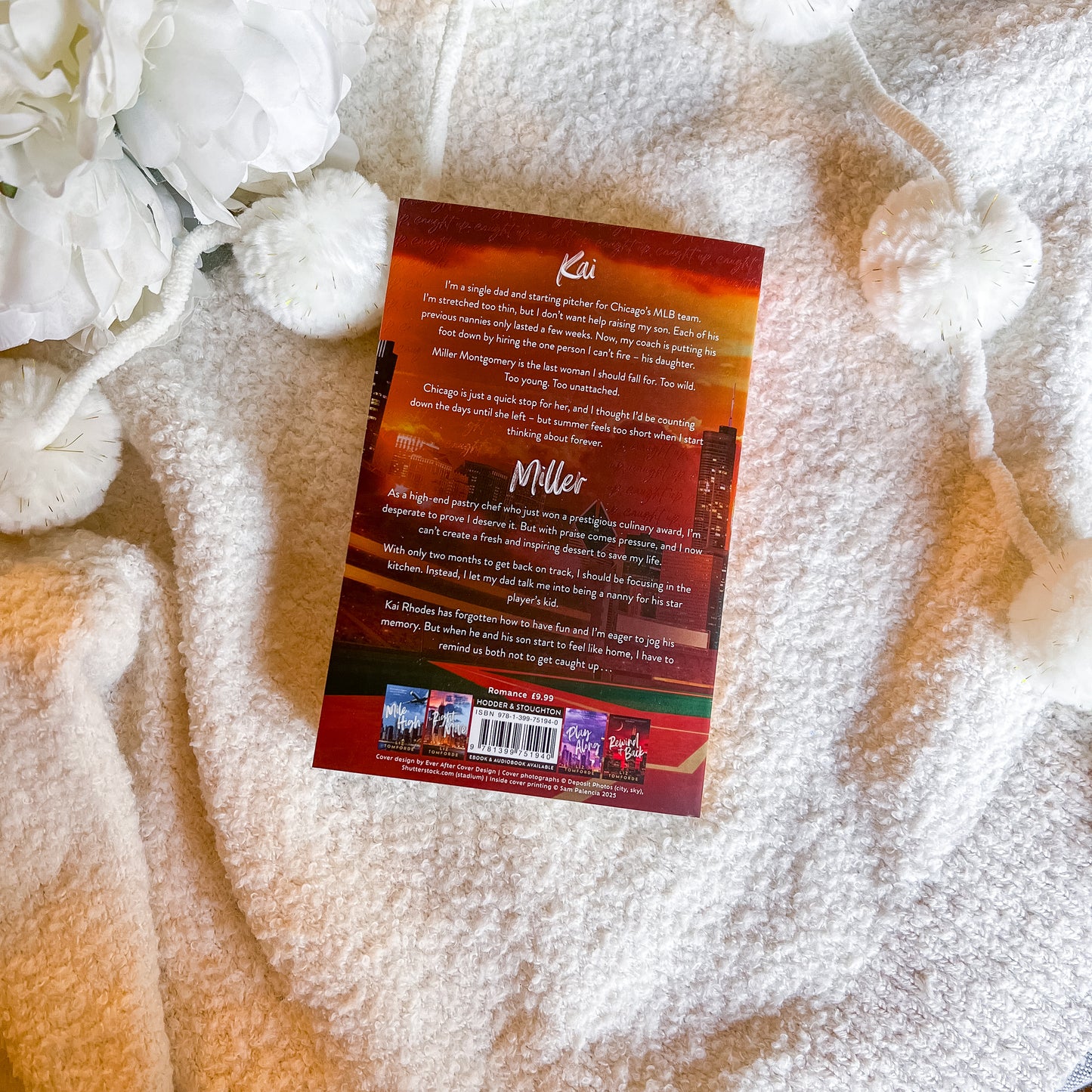 Book back cover on a textured surface with white flowers