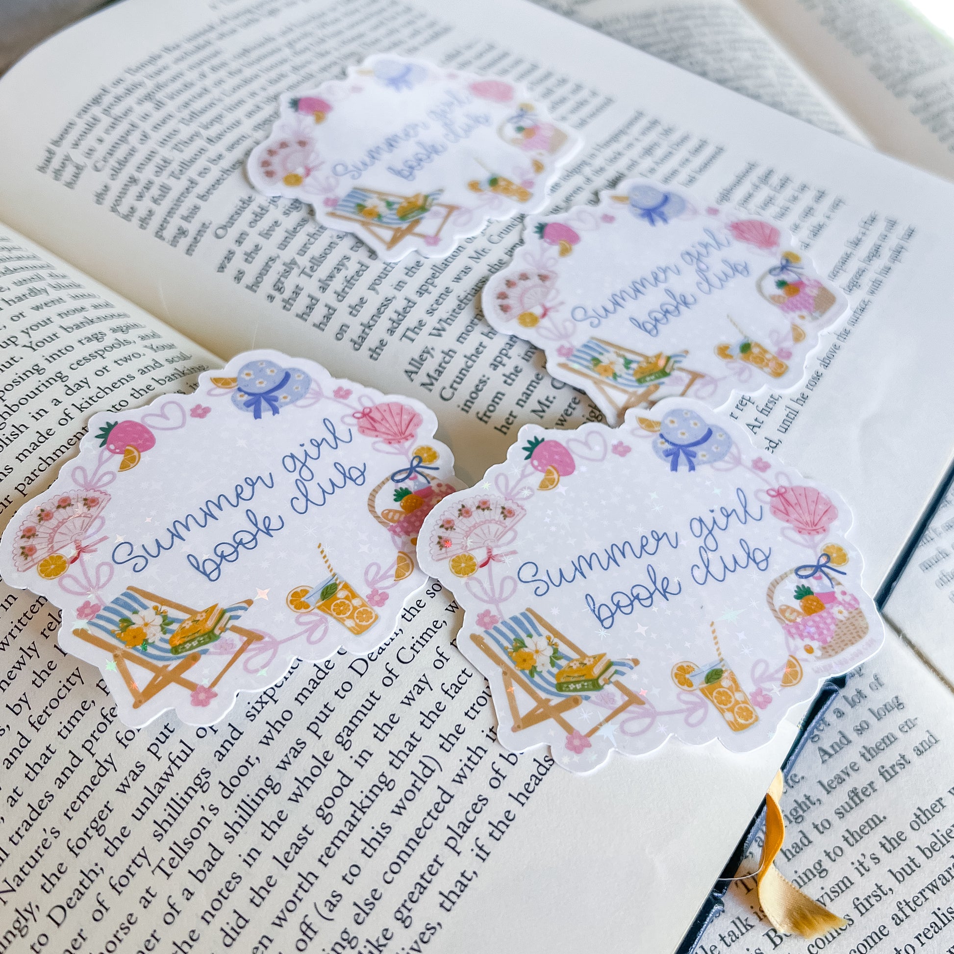 Decorative bookmarks with 'Summer girl book club' design on an open book.