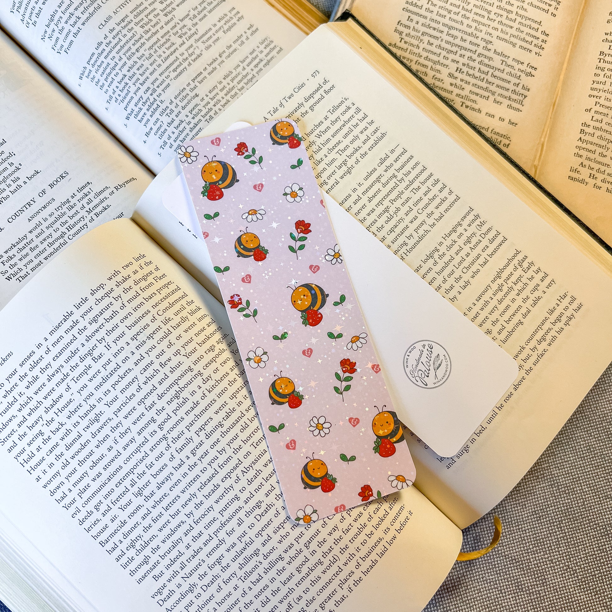 Bookmarks with bee and flower pattern on an open book