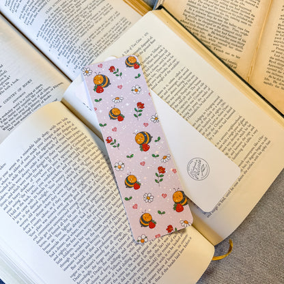 Bookmarks with bee and flower pattern on an open book