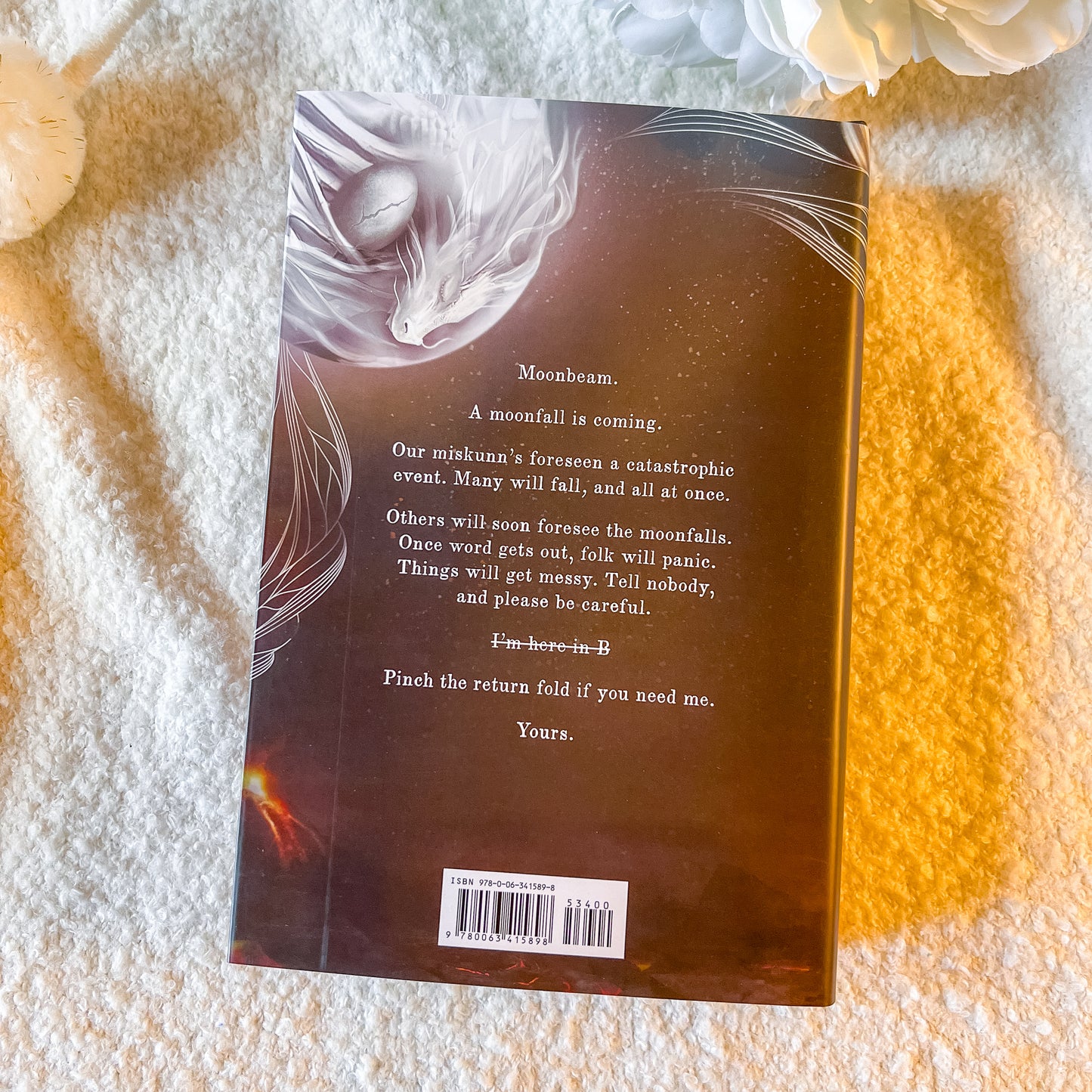 Book back cover with text and a barcode on a textured surface