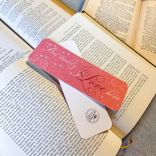 Pink and white bookmark with text on an open book