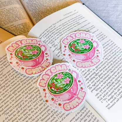 Three 'Matcha Green' themed stickers on an open book