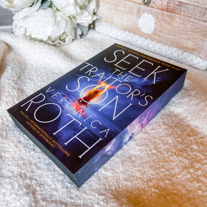 Book titled 'Seek the Son' by Veronica Roth on a textured surface with flowers in the background