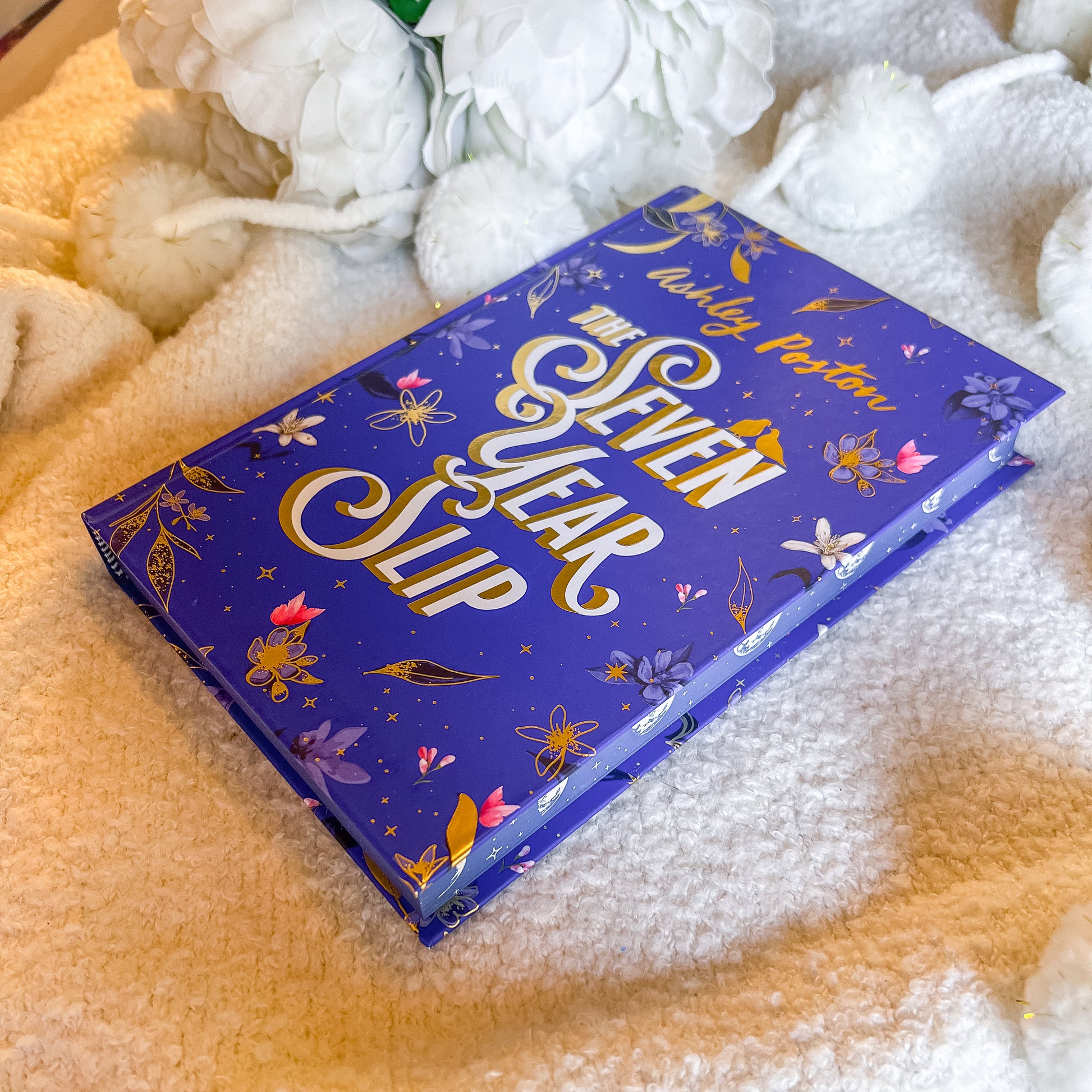 Book titled 'The Seven Year Slip' with decorative cover on a soft, white surface.