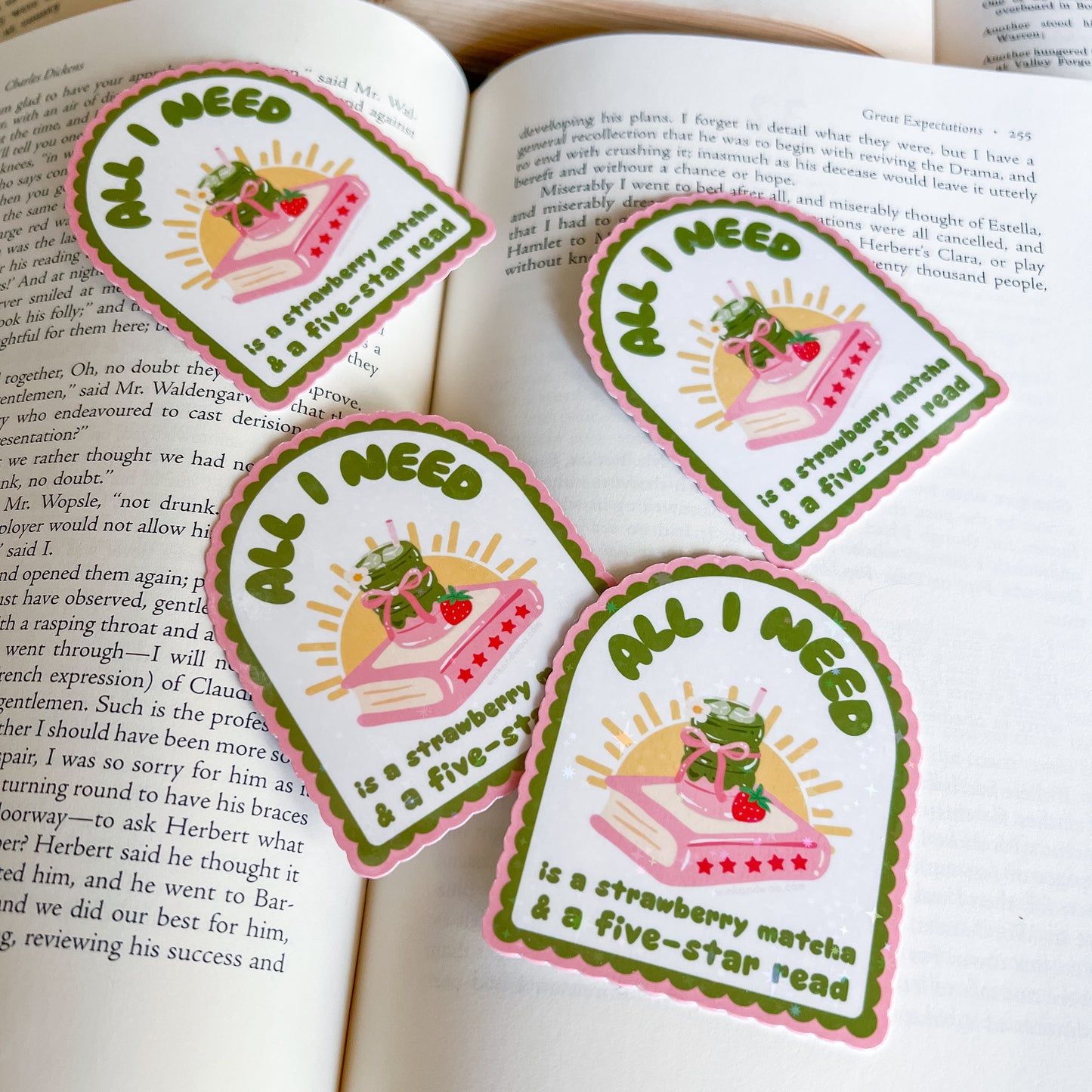 Four identical stickers with a strawberry, and book on an open book background.