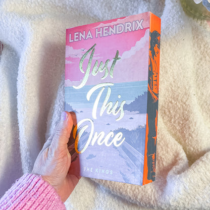 Book titled 'Just This Once' by Lena Hendrix held against a soft, light background