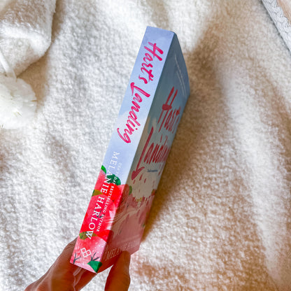 Book titled 'Hart's Landing' by Melanie Harlow on a textured surface