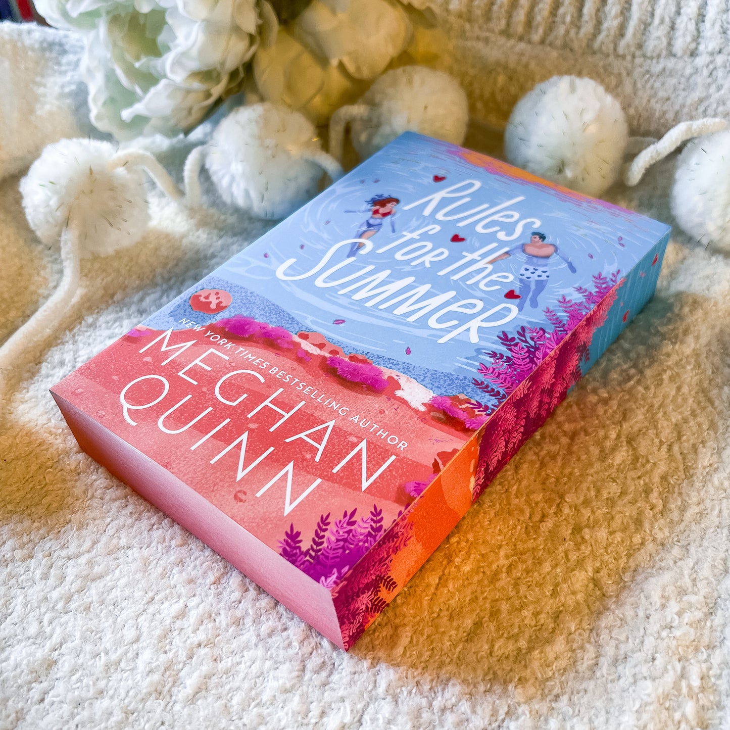 Book titled 'Rules for the Summer' by Mechan Quinn on a textured surface with decorative elements.