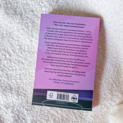 Purple book back cover with text on a textured surface