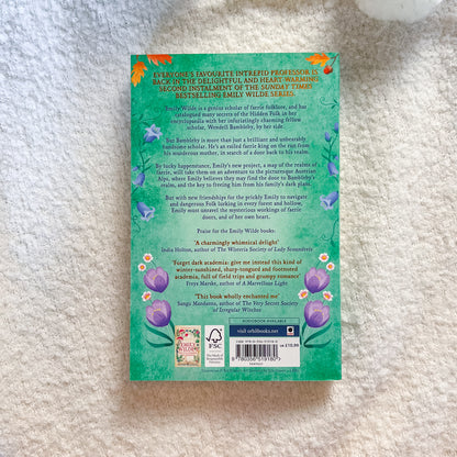 Book back cover with text and floral designs on a textured surface