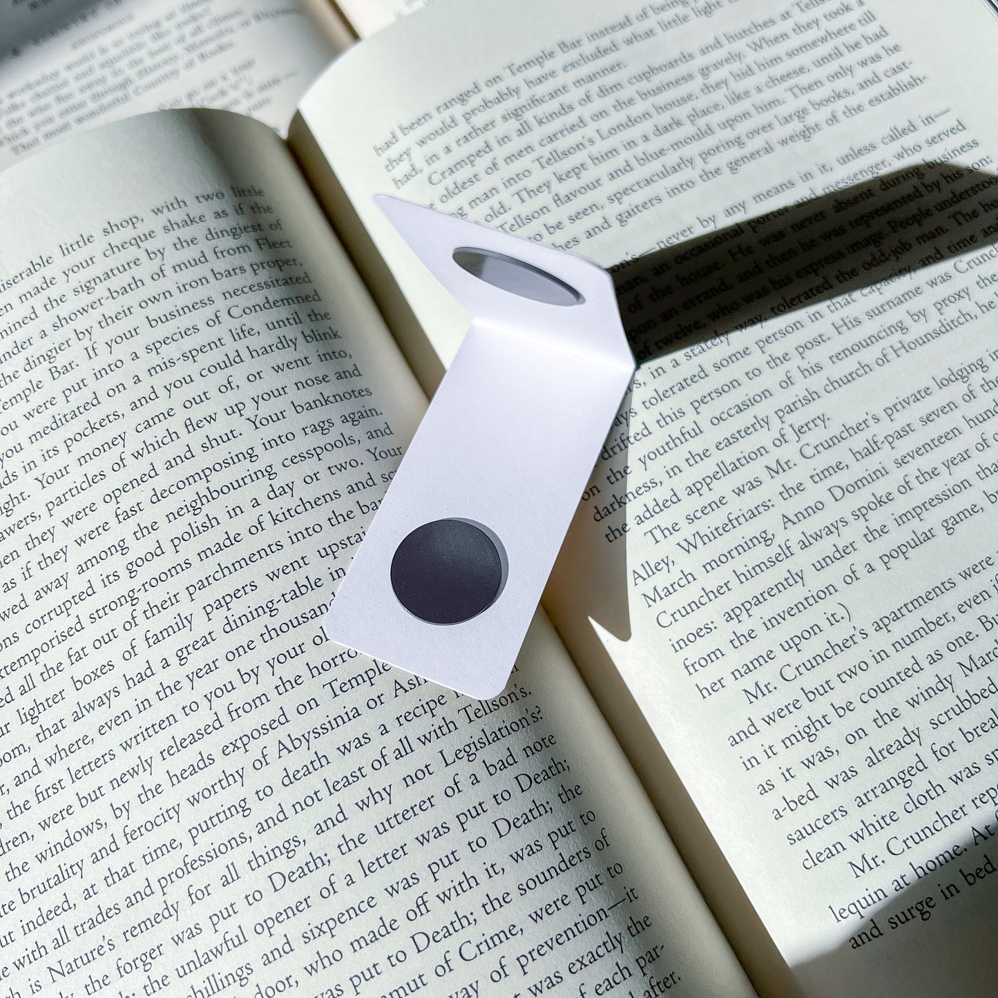 Magnetic bookmark with a black center on an open book