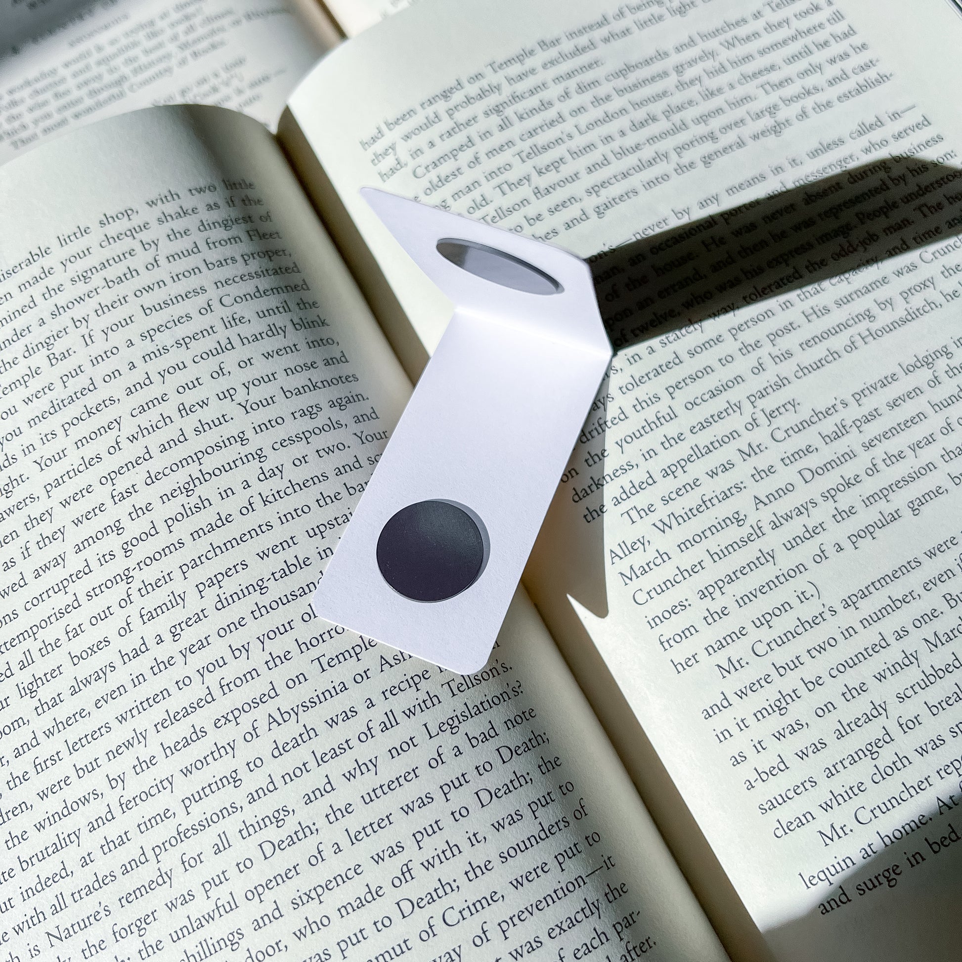 Magnetic bookmark with a black center on an open book