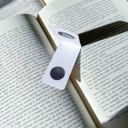Magnetic bookmark with a black center on an open book