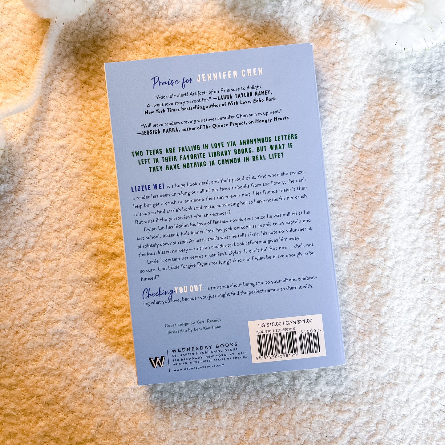 The back cover of the book by Wednesday Books, photographed flat on a textured beige fabric background.