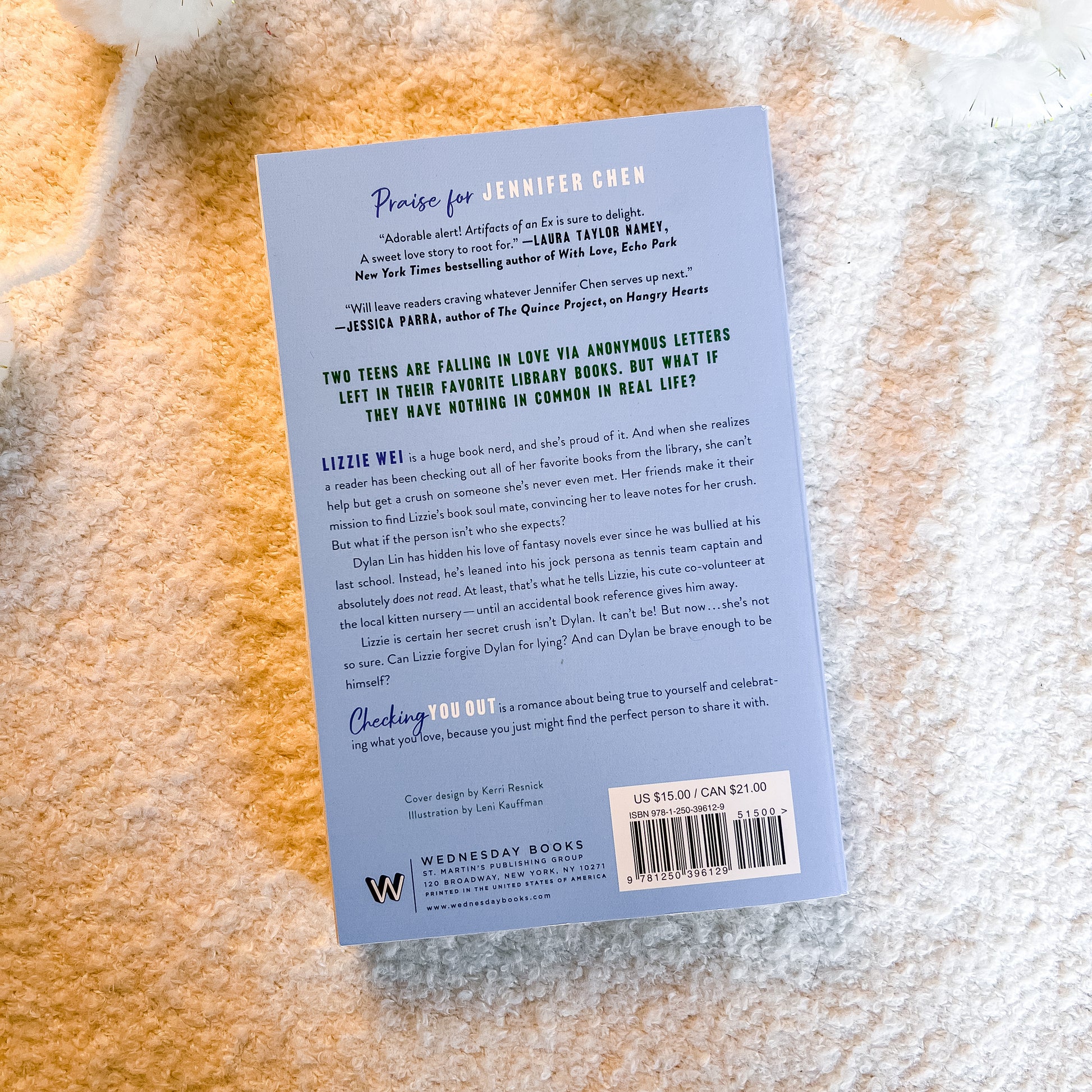 The back cover of the book by Wednesday Books, photographed flat on a textured beige fabric background.