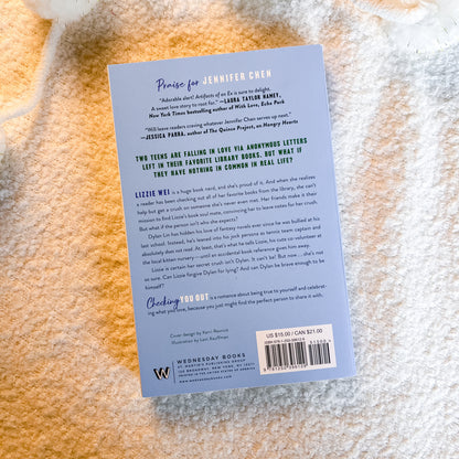 The back cover of the book by Wednesday Books, photographed flat on a textured beige fabric background.