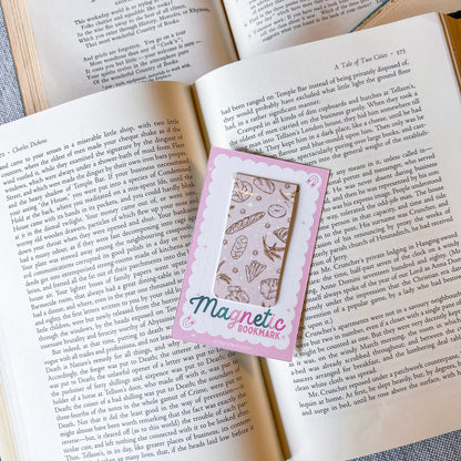 Magnetic bookmark with a pink border on an open book