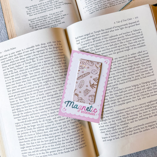 Magnetic bookmark with a pink border on an open book