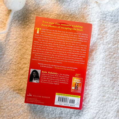 The back cover of the book 'One Summer Wedding' by Billie Eilish, featuring a bright orange-red background with white text, a small portrait of Billie Eilish, and a Honey Beast album cover graphic, photographed on a white textured blanket.