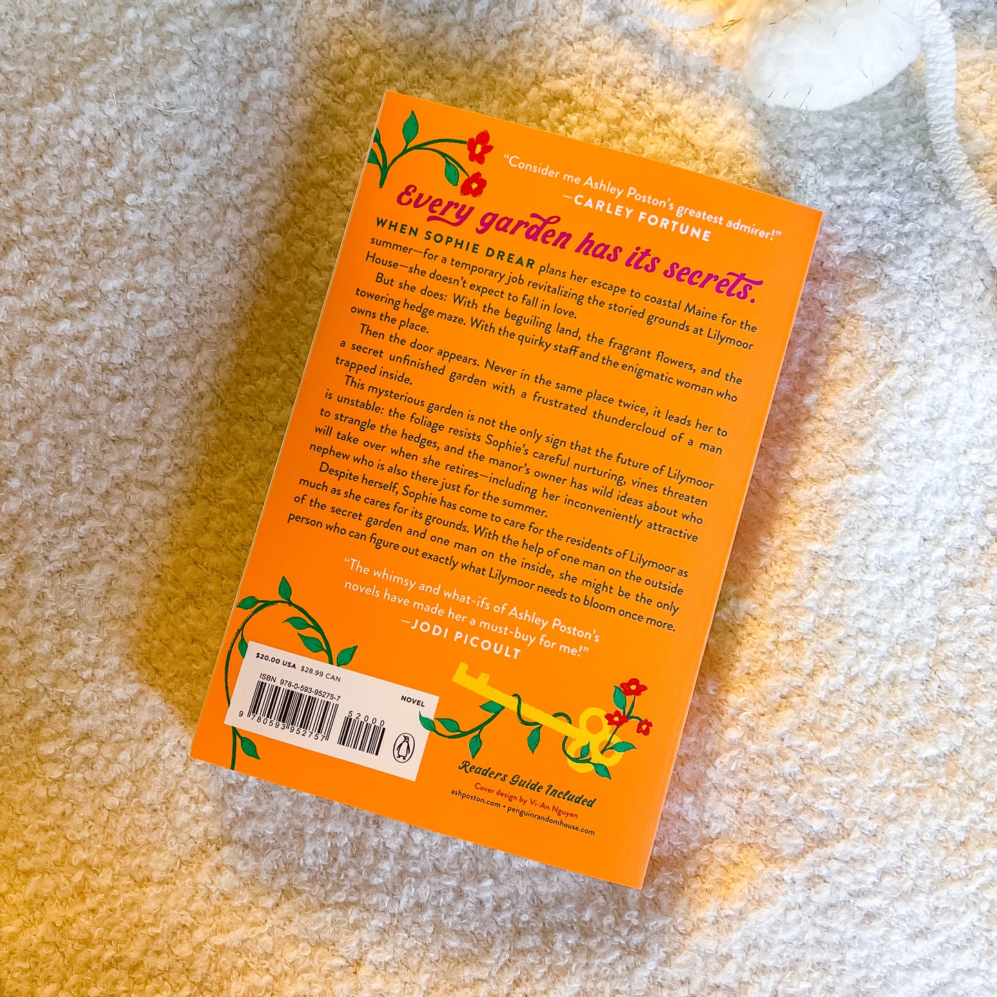 Book with orange back cover on a textured surface