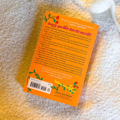 Book with orange back cover on a textured surface