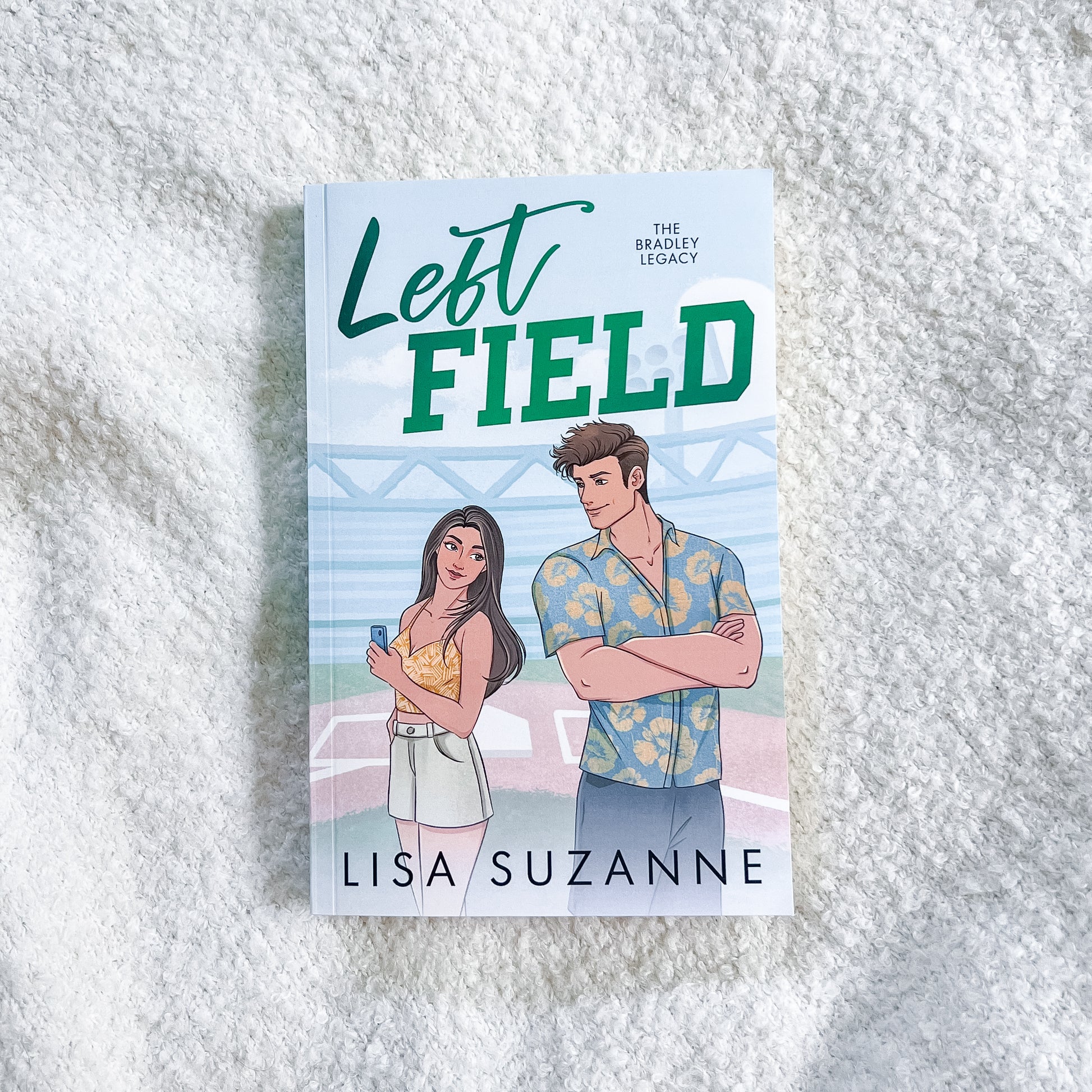 Book cover of 'Left Field' by Lisa Suzanne on a textured white surface