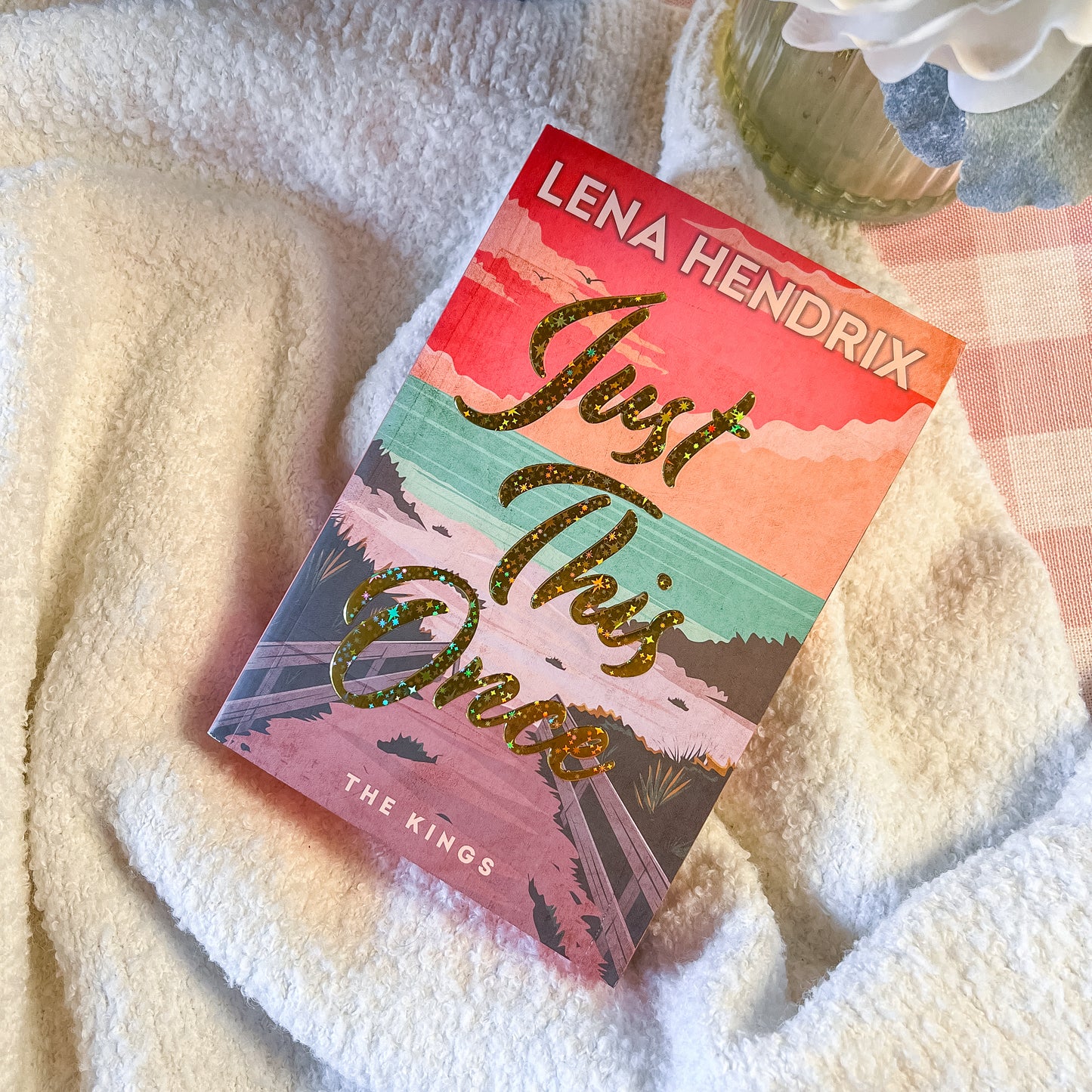 Colorful book titled 'Just This Once' by Lena Hendrix on a textured surface