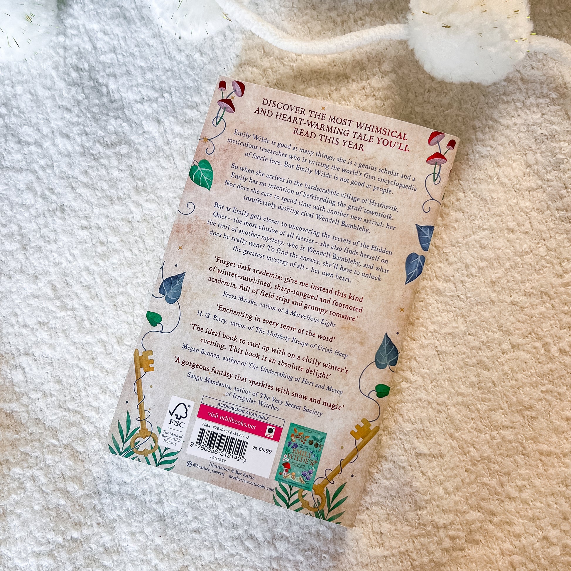Book with a decorative back cover on a textured surface
