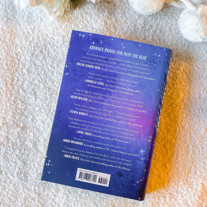 Book with a purple back cover on a textured surface
