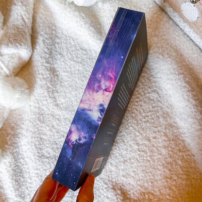 Book with a colorful design held by a hand on a textured surface