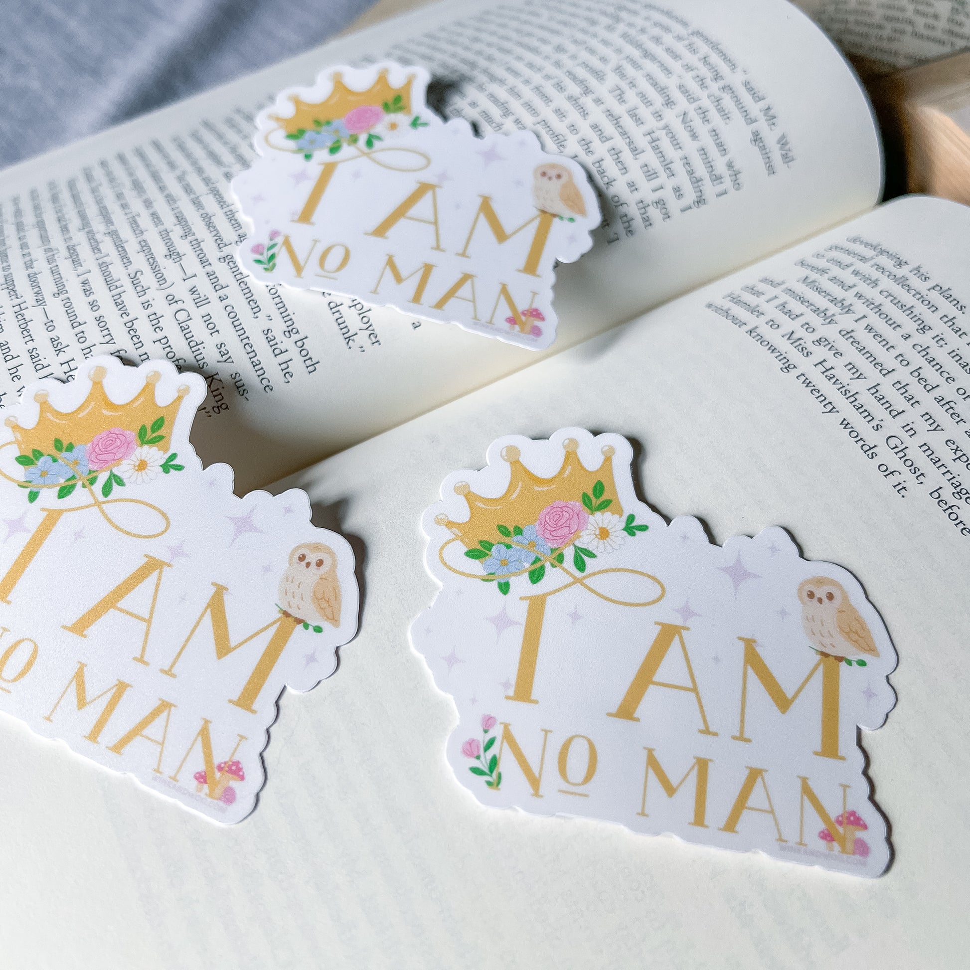 Stickers with 'I AM NO MAN' text on a book