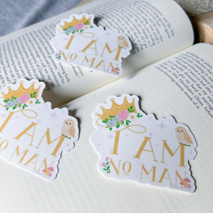 Stickers with 'I AM NO MAN' text on a book
