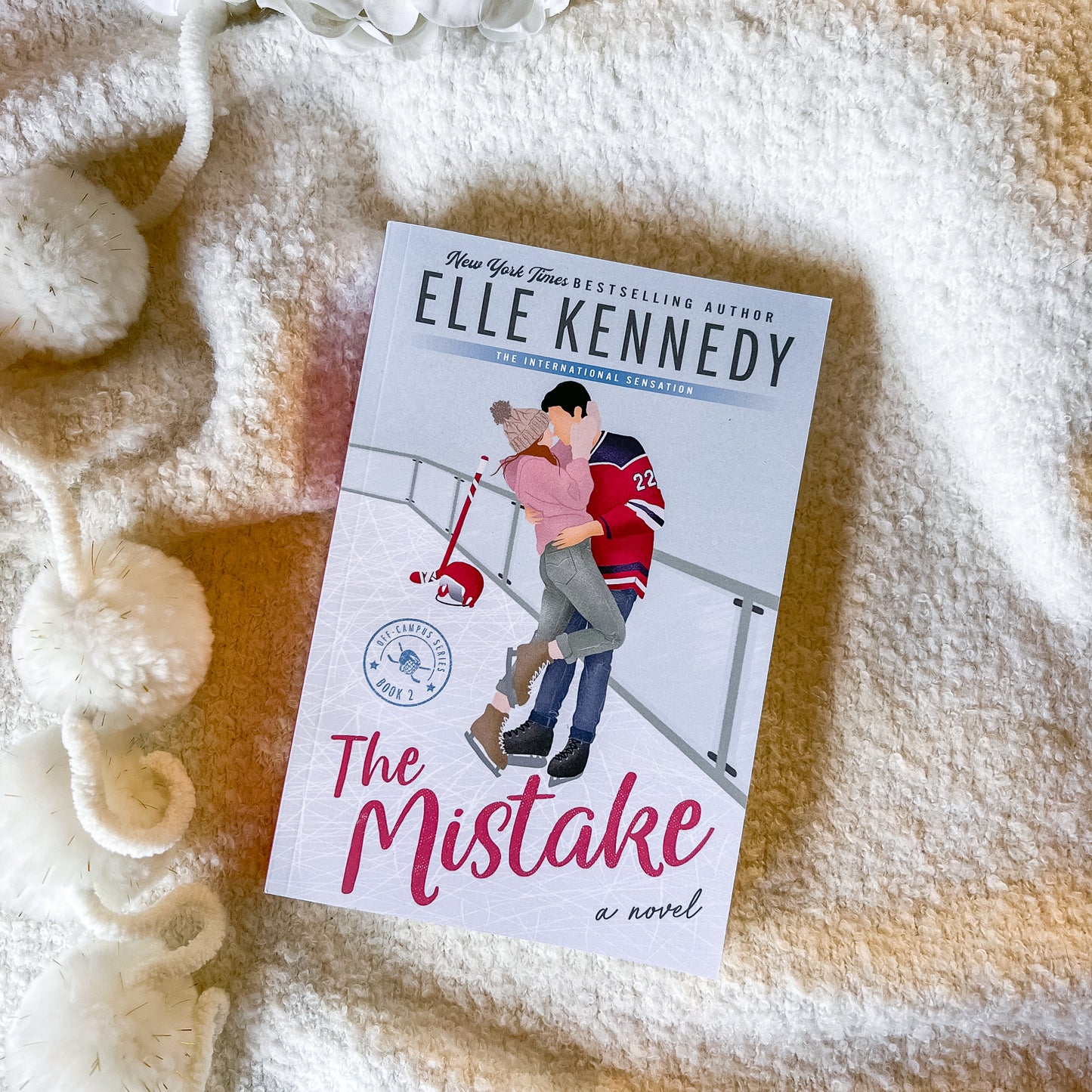 Book titled 'The Mistake' by Elle Kennedy on a textured surface